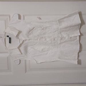 White sleeveless button down shirt with peplum style waist